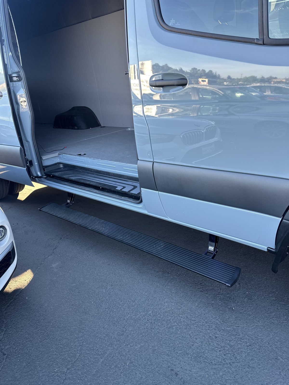 AMP powered side step deployed under the sliding door